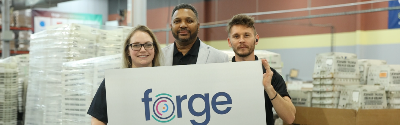 workers holding a sign with the forge logo on it